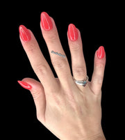Bikini Babe is a nail dip powder of a vibrant red hue. 